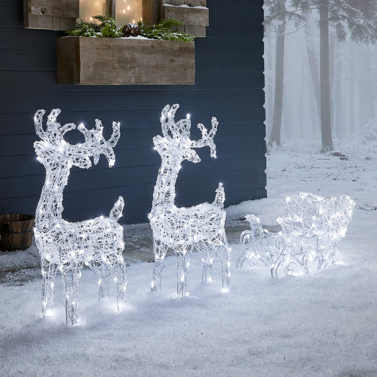 Bicolor LED-Rentiere mit Schlitten Swinsty